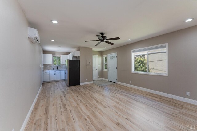 kitchen with sink, stainless steel appliances, light hardwood / wood-style flooring, and white cabinets