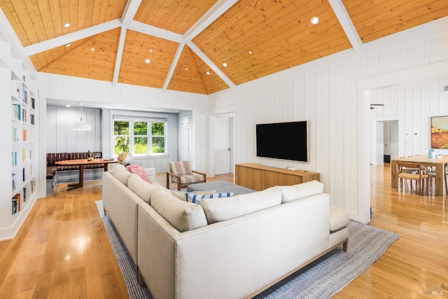 living room with beamed ceiling, wood ceiling, and light hardwood / wood-style flooring