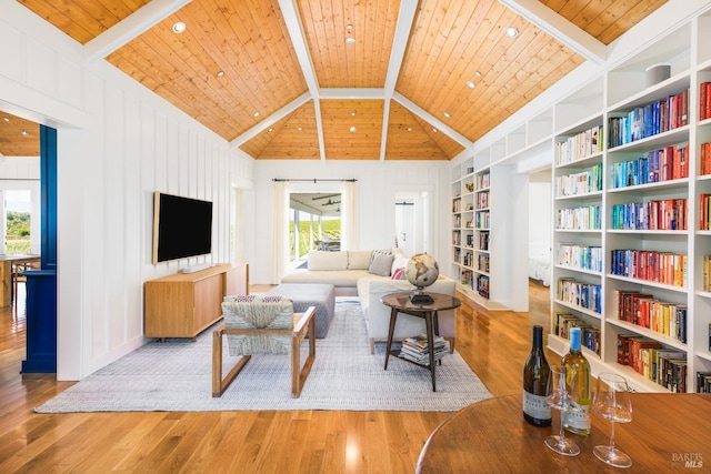 living room featuring beamed ceiling, built in shelves, hardwood / wood-style floors, high vaulted ceiling, and wood ceiling