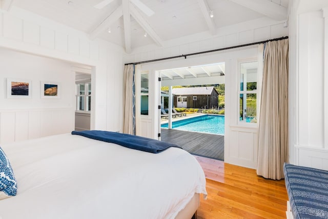 bedroom with ceiling fan, vaulted ceiling with beams, hardwood / wood-style floors, and access to outside