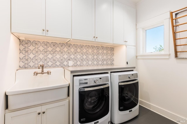 washroom with independent washer and dryer, sink, and cabinets