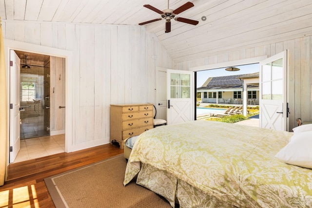 tiled bedroom with wood walls, ceiling fan, wood ceiling, and lofted ceiling