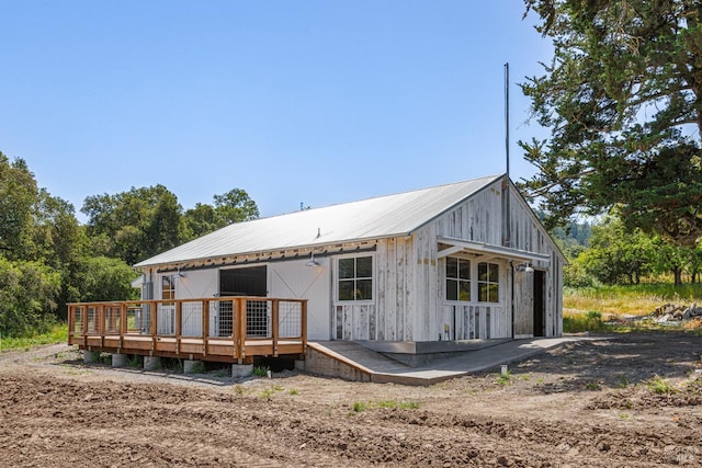 back of house featuring a patio area and a wooden deck