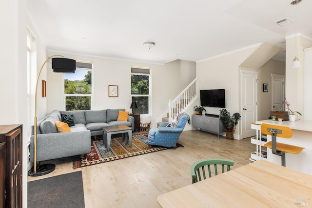 living room with hardwood / wood-style flooring and ornamental molding