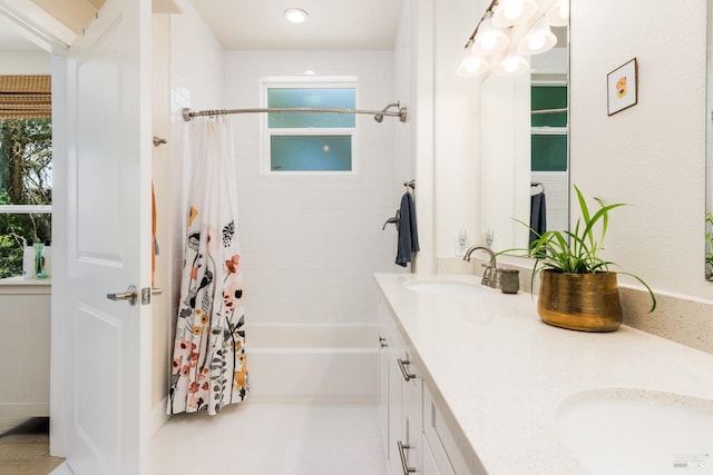 bathroom with shower / tub combo with curtain and double sink vanity