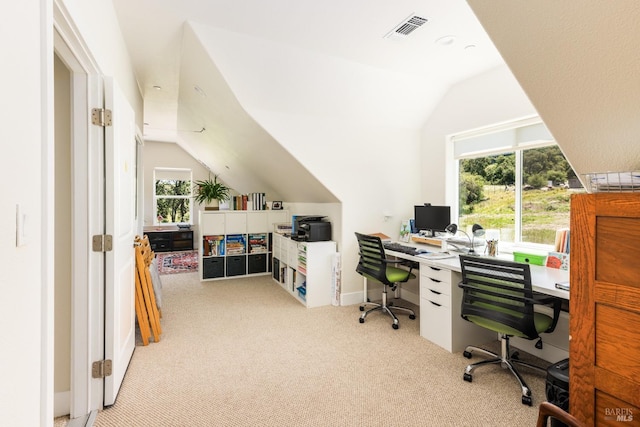 carpeted home office featuring lofted ceiling