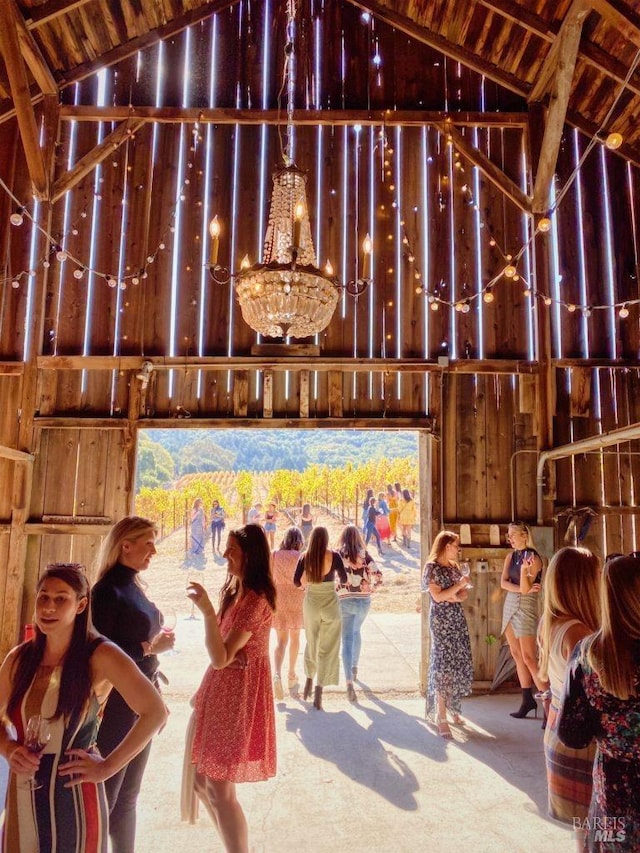 miscellaneous room with lofted ceiling and a chandelier