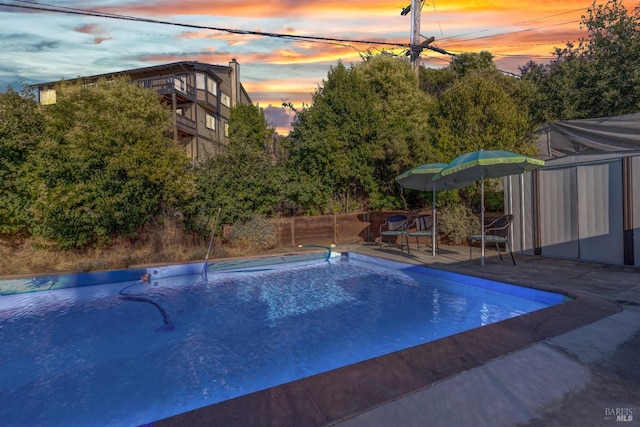 view of pool at dusk