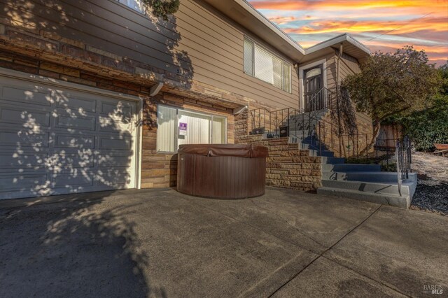 property exterior at dusk featuring a garage