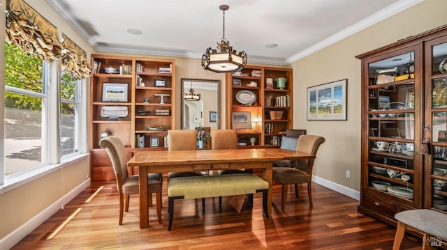 dining area featuring hardwood / wood-style flooring and crown molding