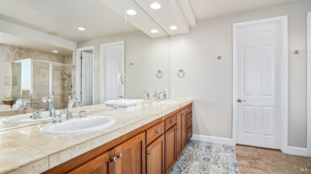 bathroom with tile patterned flooring, an enclosed shower, and vanity