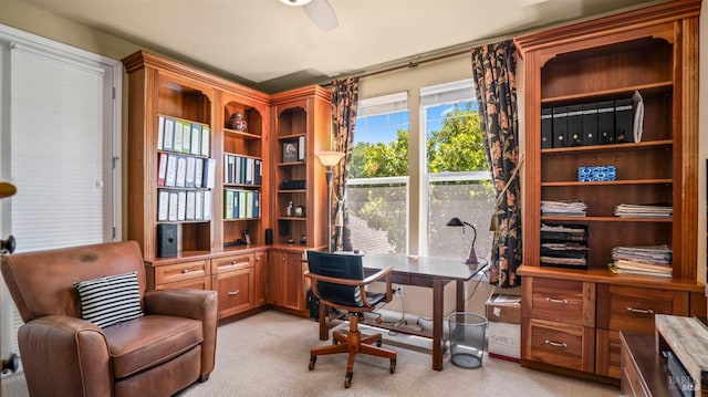 carpeted office space with ceiling fan