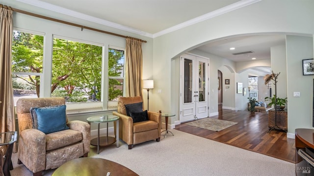 living area featuring hardwood / wood-style flooring and crown molding