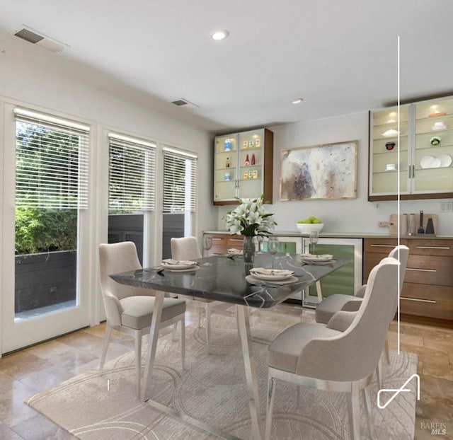 dining space featuring beverage cooler, visible vents, and recessed lighting