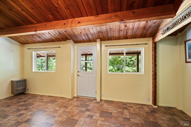 interior space with beam ceiling, a wealth of natural light, and wooden ceiling