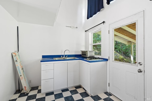 kitchen with sink, white cabinets, and stainless steel gas cooktop