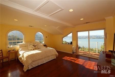 bedroom with a water view, attic access, wood finished floors, and access to outside