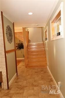 corridor with stairway and baseboards