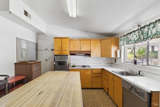 kitchen featuring vaulted ceiling, oven, sink, dark tile flooring, and black dishwasher