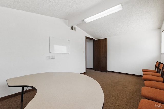 interior space featuring a textured ceiling, vaulted ceiling with beams, and dark carpet