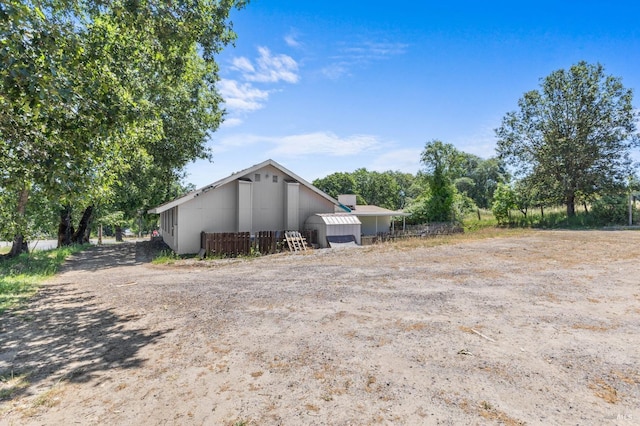 view of property exterior with an outdoor structure