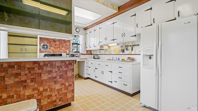 kitchen with white fridge with ice dispenser, light floors, light countertops, and white cabinets