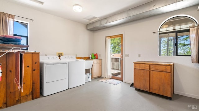 laundry room featuring cabinet space, washer and clothes dryer, and baseboards