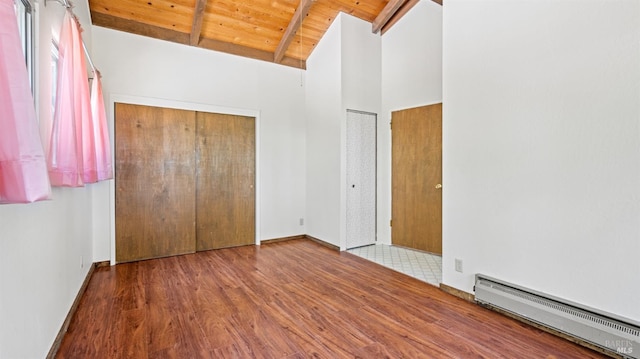 unfurnished bedroom with wooden ceiling, a baseboard radiator, beamed ceiling, wood finished floors, and high vaulted ceiling