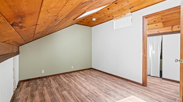 additional living space with light wood-type flooring, wooden ceiling, lofted ceiling, and baseboards