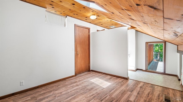 bonus room featuring visible vents, lofted ceiling with skylight, wood ceiling, wood finished floors, and baseboards