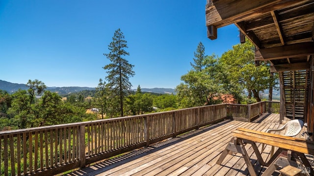 wooden deck with a mountain view