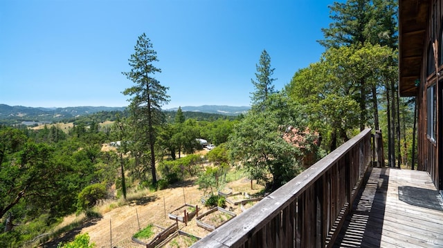 balcony with a wooded view and a mountain view