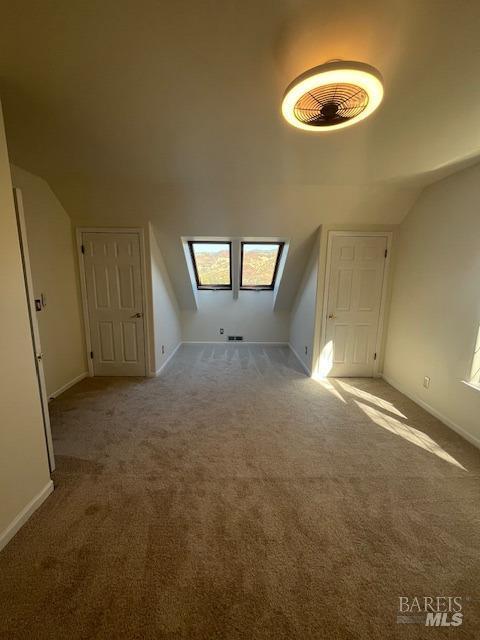 bonus room featuring carpet floors and lofted ceiling