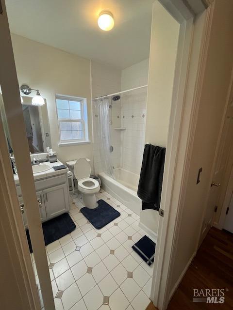 full bathroom with toilet, tile patterned floors, vanity, and shower / bathtub combination with curtain