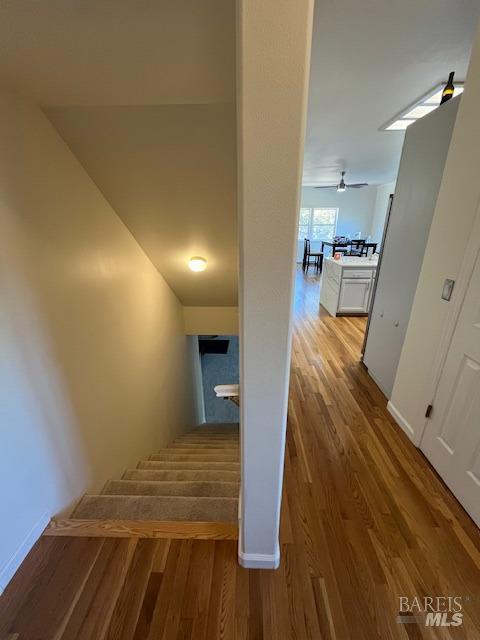 hall featuring light wood-style floors and baseboards