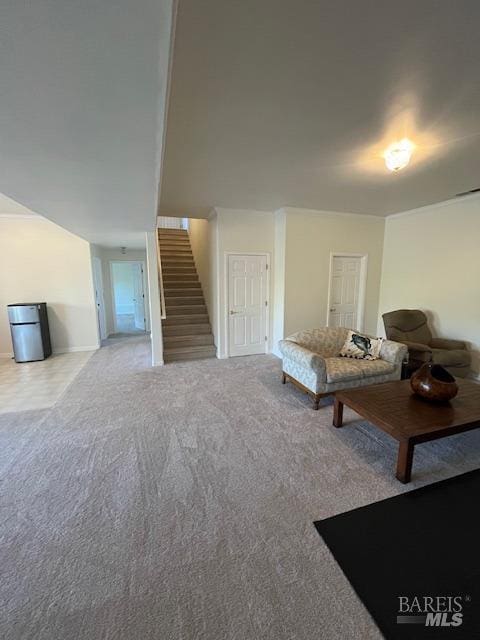 carpeted living room with stairs