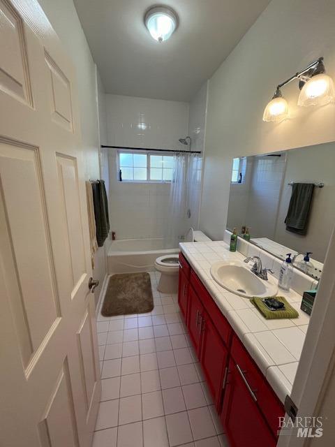 bathroom featuring toilet, tile patterned floors, shower / bath combo, and vanity