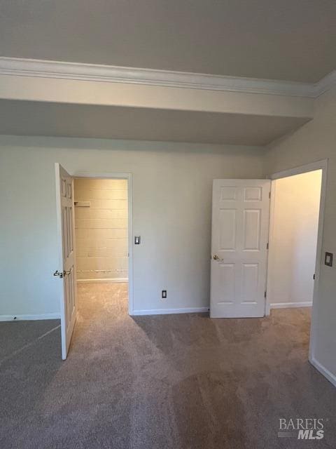 interior space with crown molding, baseboards, and carpet flooring