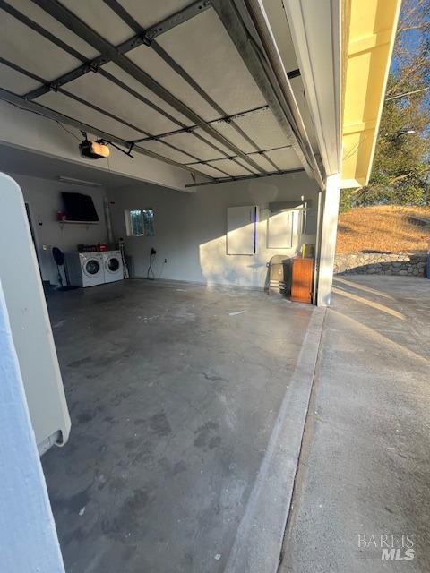 garage featuring a garage door opener and washer and clothes dryer