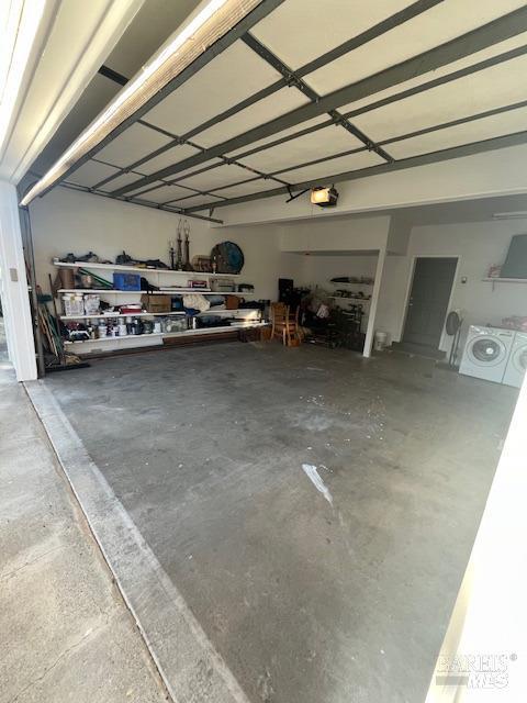 garage with washer / dryer and a garage door opener