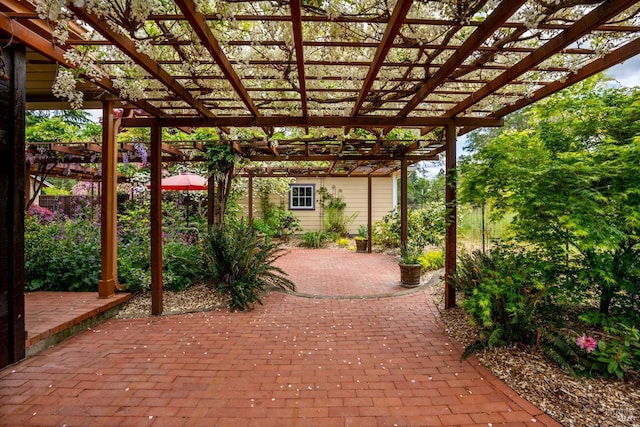 view of patio with a pergola and an outdoor structure