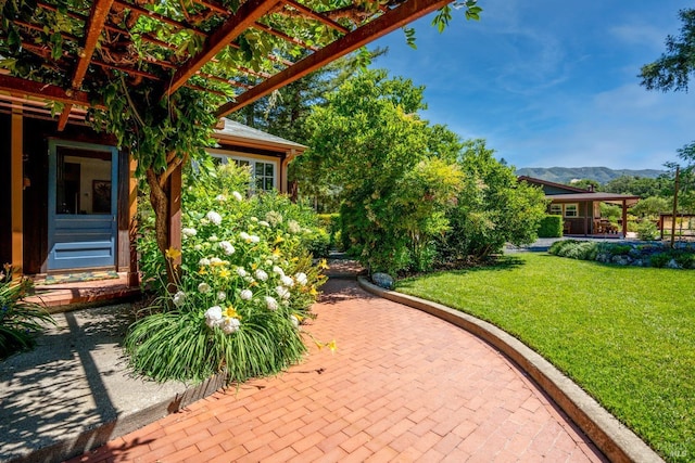 view of patio / terrace featuring a mountain view and a pergola