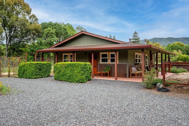 view of front of property with a mountain view and a patio area