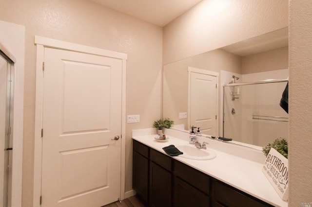 bathroom featuring an enclosed shower and vanity