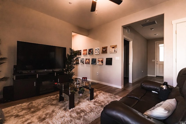 living room with wood-type flooring and ceiling fan