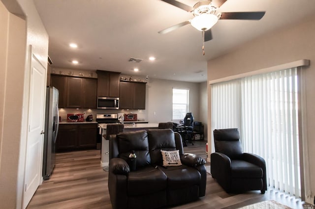 living room with ceiling fan and hardwood / wood-style floors