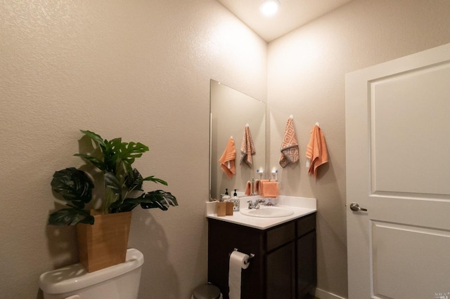 bathroom with oversized vanity and toilet