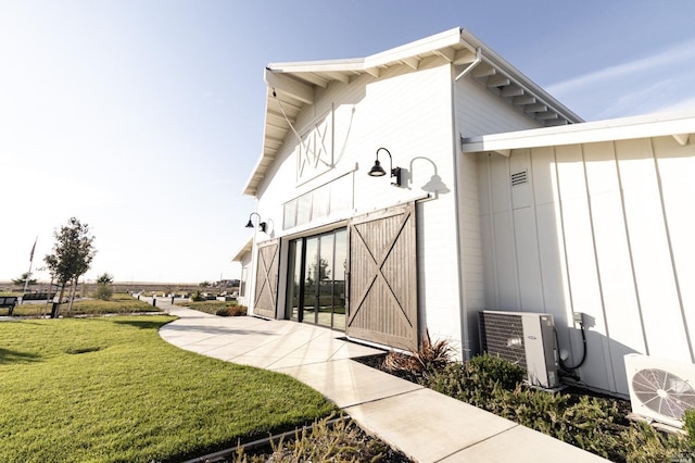 property entrance with a yard and central AC