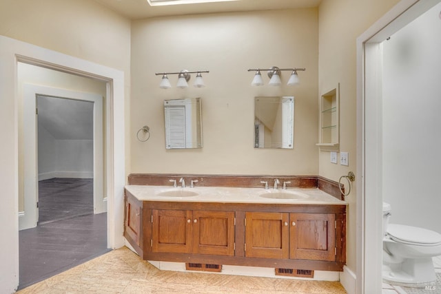 bathroom with vanity, tile patterned flooring, and toilet