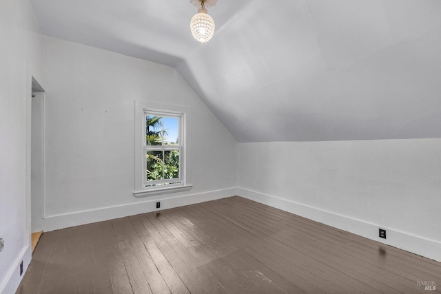 bonus room with wood-type flooring and vaulted ceiling